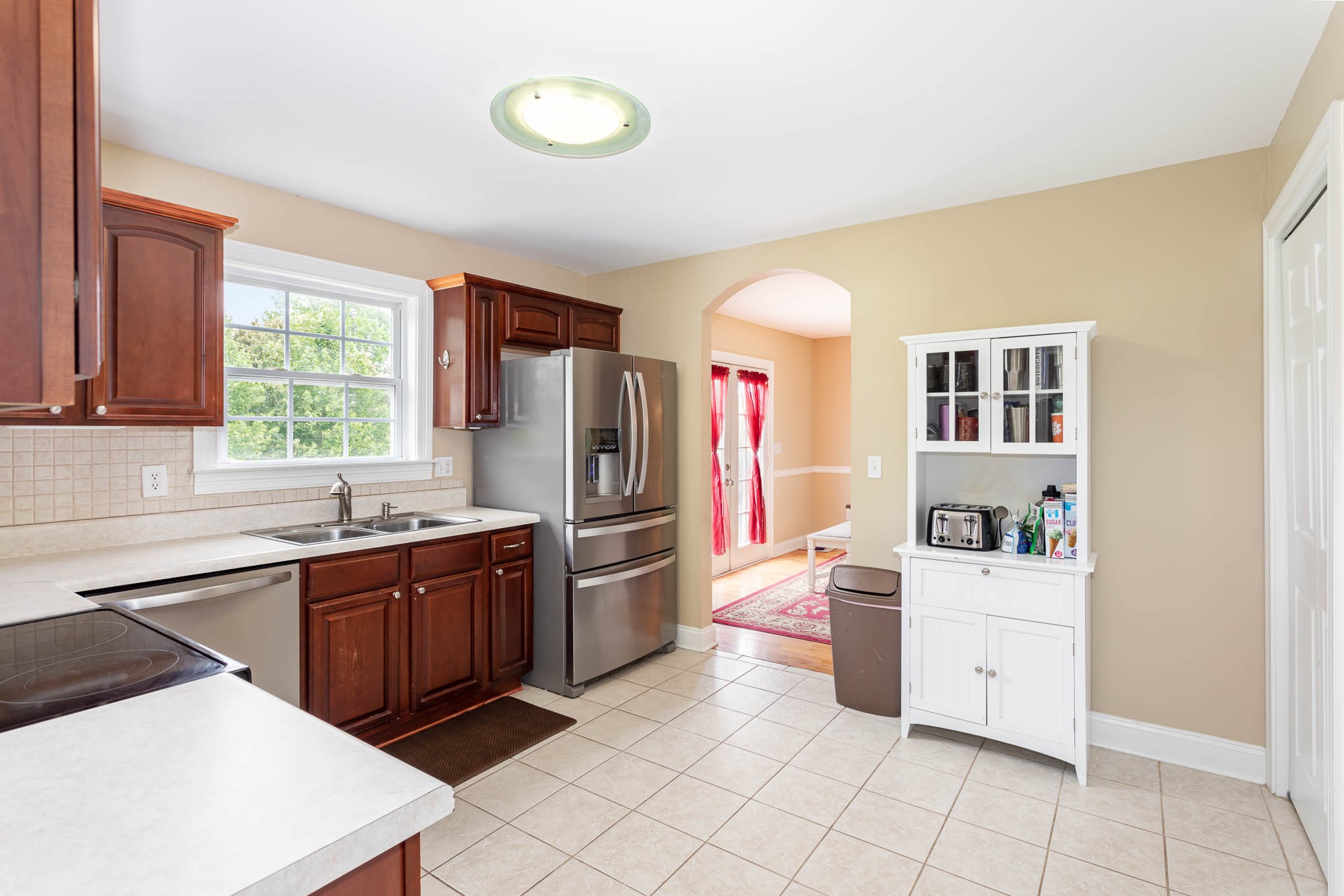 817 Blakemore Road Dickson, TN 37055 - Photo 12 of 30 a kitchen with stainless steel appliances a sink a stove a refrigerator cabinets and a window