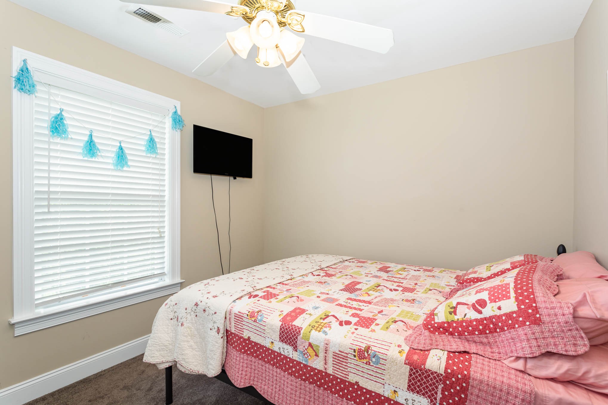 817 Blakemore Road Dickson, TN 37055 - Photo 22 of 30 a bedroom with a bed and a flat screen tv