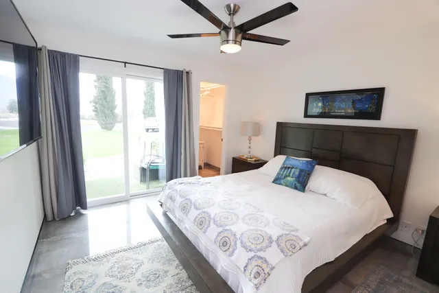 a bedroom with a large bed and a window