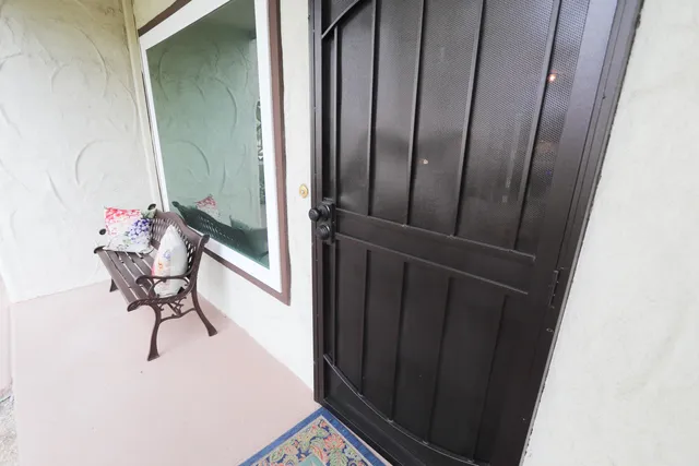 a view of a hallway with furniture and a potted plant