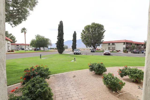 a view of a house with backyard sitting area and swimming pool