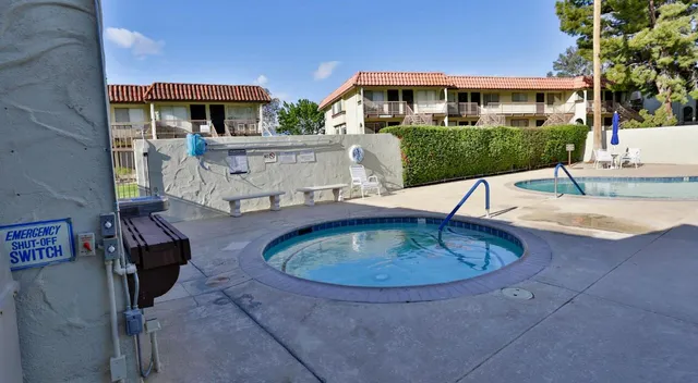 a view of a house with a big yard and large trees