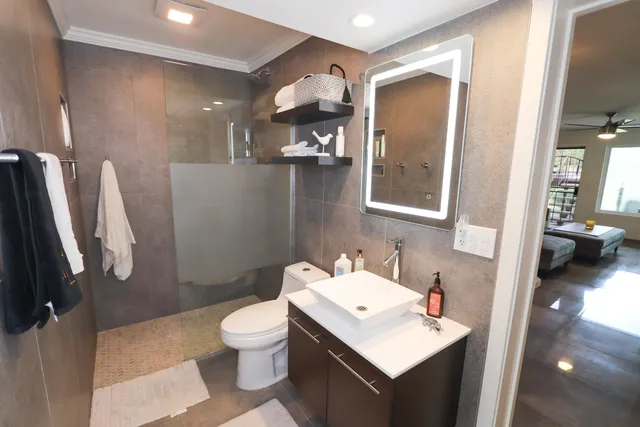 a bathroom with a sink toilet and shower