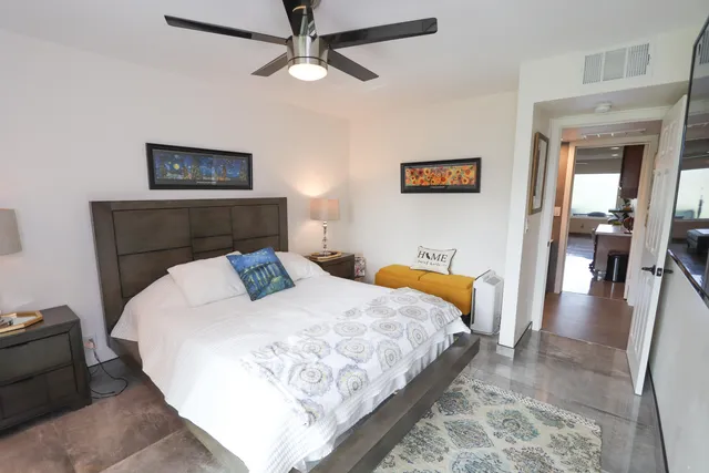 a bedroom with a bed and a mirror