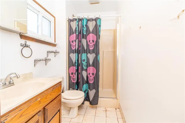 a bathroom with a sink mirror vanity and toilet