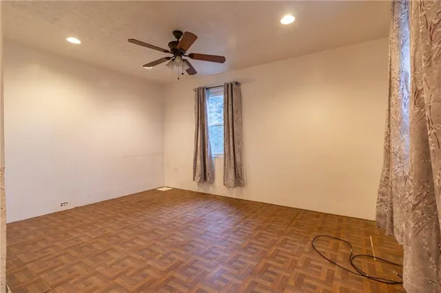 a view of a livingroom with a ceiling fan and window
