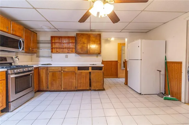 a kitchen with stainless steel appliances granite countertop a stove a sink and a refrigerator