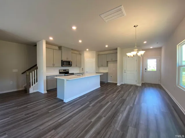 a view of kitchen with sink microwave and stove