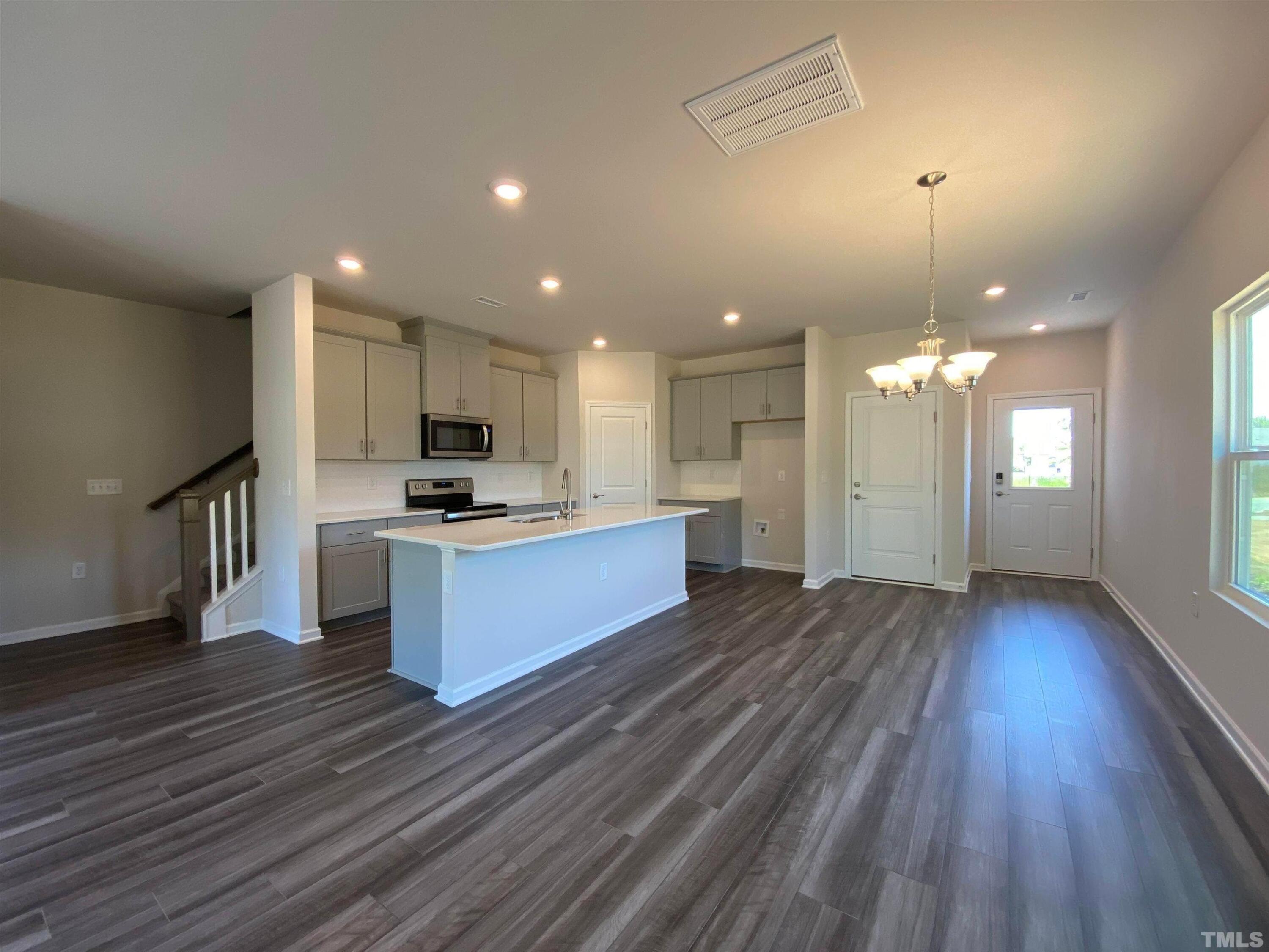 a view of kitchen with sink microwave and stove