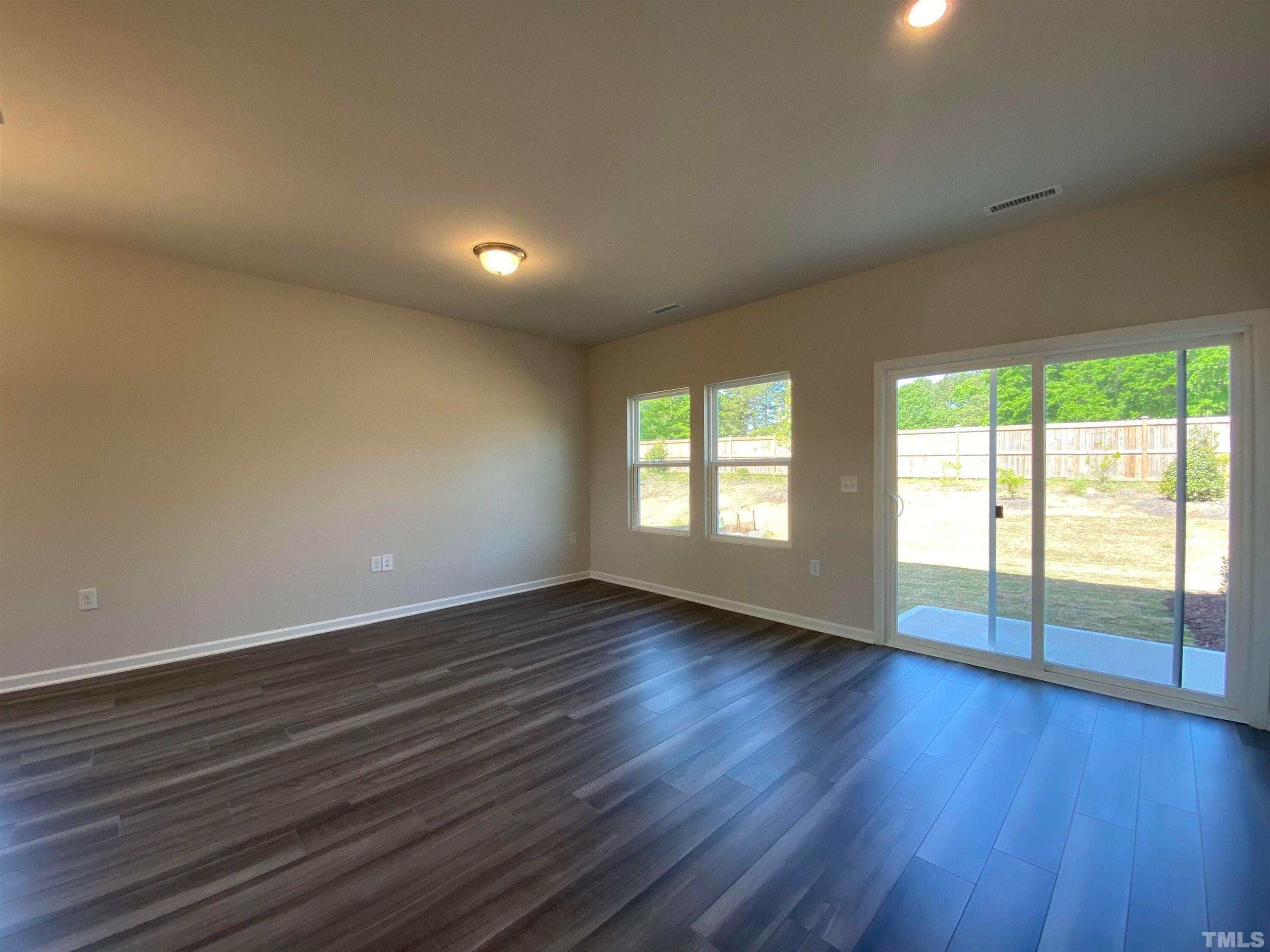908 Clearhaven Lane Fuquay-Varina, NC 27526 - Photo 17 of 23 a view of an empty room with wooden floor and a window
