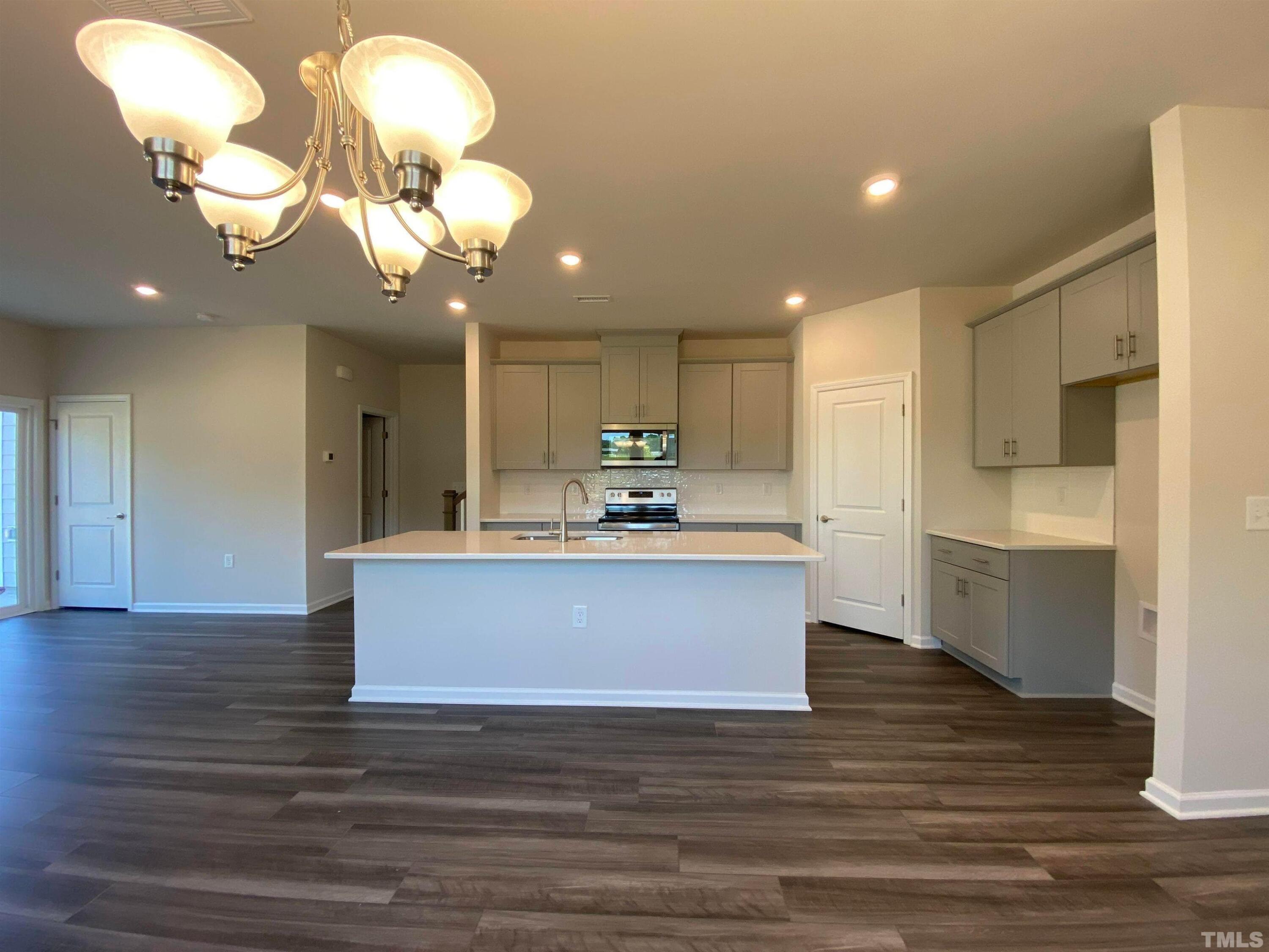 908 Clearhaven Lane Fuquay-Varina, NC 27526 - Photo 2 of 23 a view of kitchen with granite countertop cabinets table and chairs
