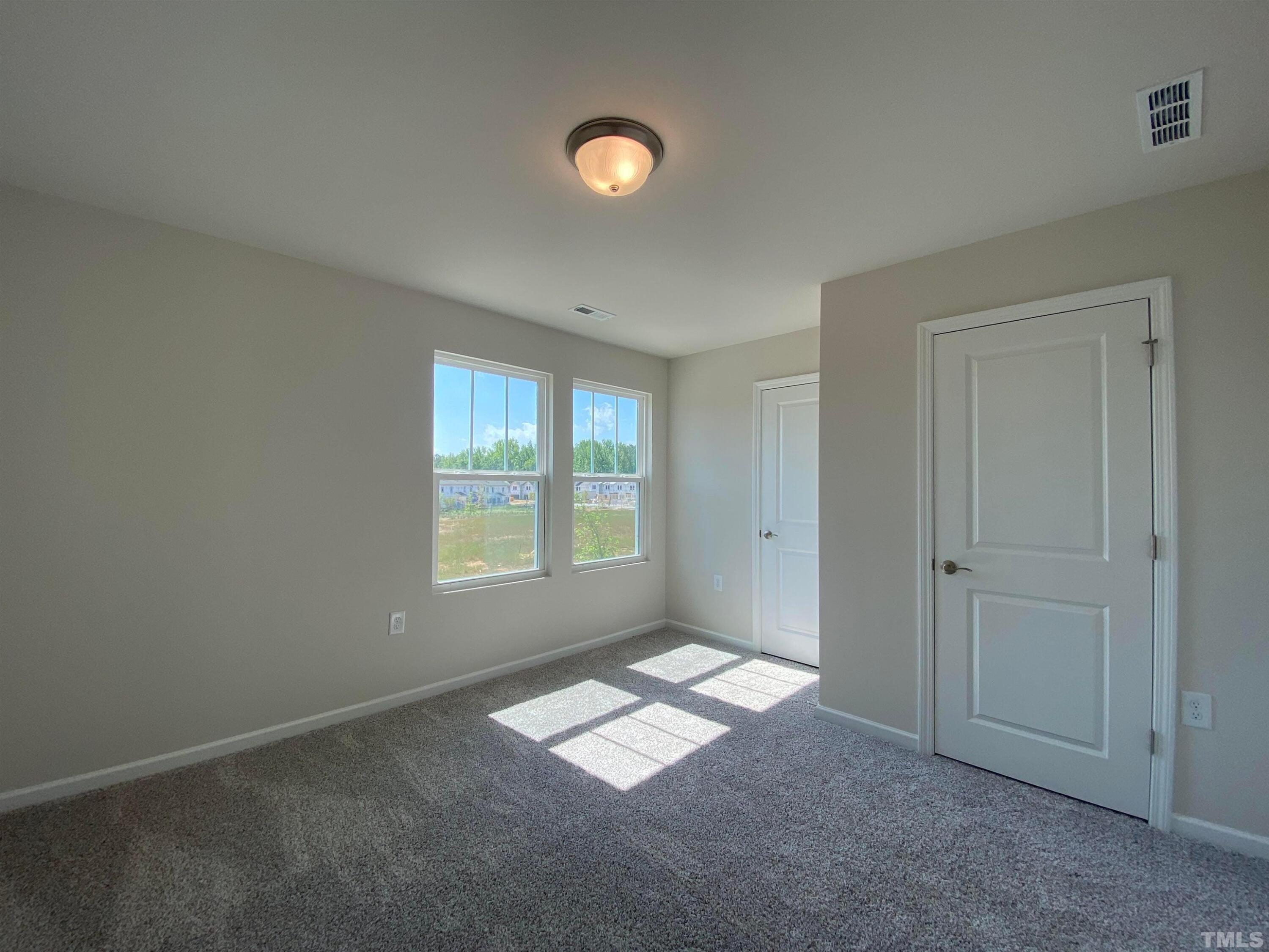 908 Clearhaven Lane Fuquay-Varina, NC 27526 - Photo 21 of 23 an empty room with windows
