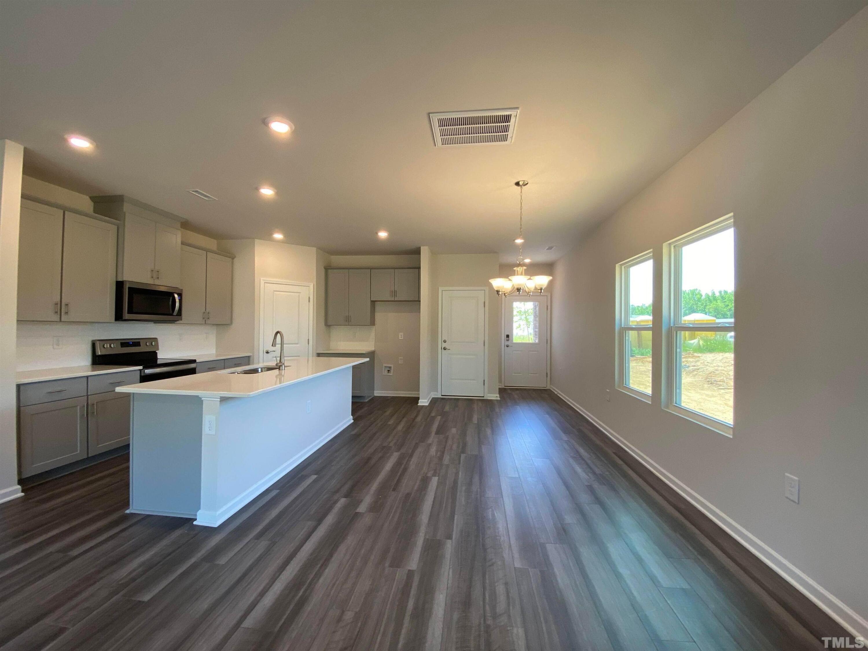 908 Clearhaven Lane Fuquay-Varina, NC 27526 - Photo 3 of 23 a large kitchen with stainless steel appliances granite countertop a large counter top a sink and a dishwasher