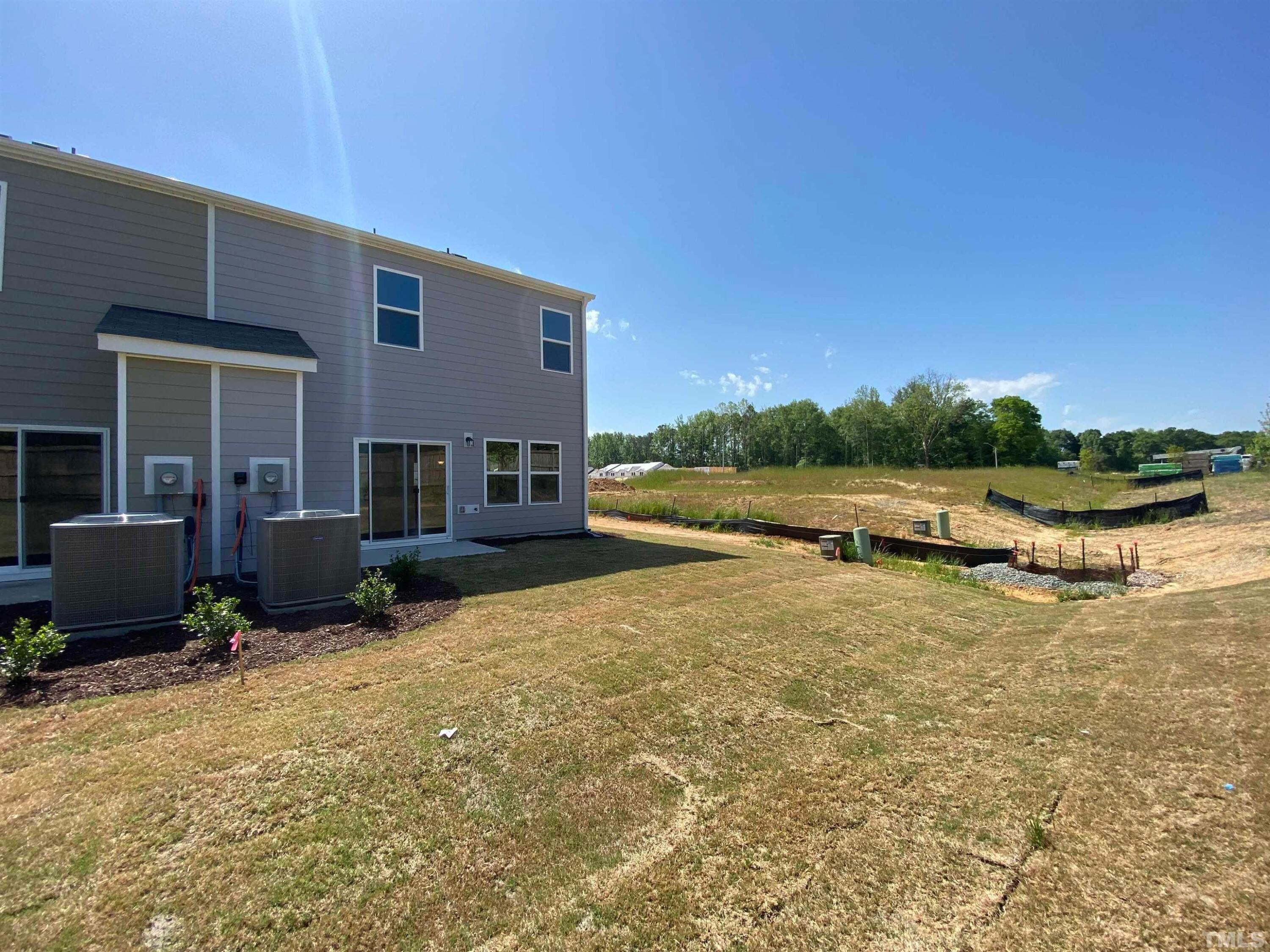 908 Clearhaven Lane Fuquay-Varina, NC 27526 - Photo 8 of 23 a view of a house with a yard and sitting area