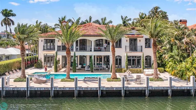 a view of a house with swimming pool and sitting area