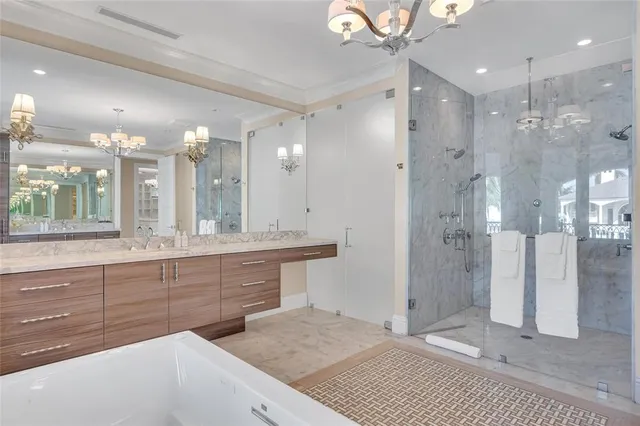 a bathroom with a sink a shower a mirror and a shower