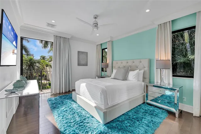 a bedroom with a large bed and a potted plant