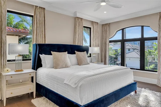 a bedroom with a large bed and a large window