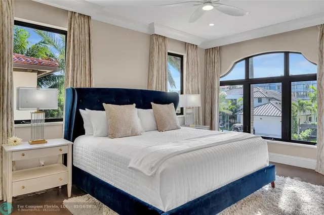 a bedroom with a large bed and a large window