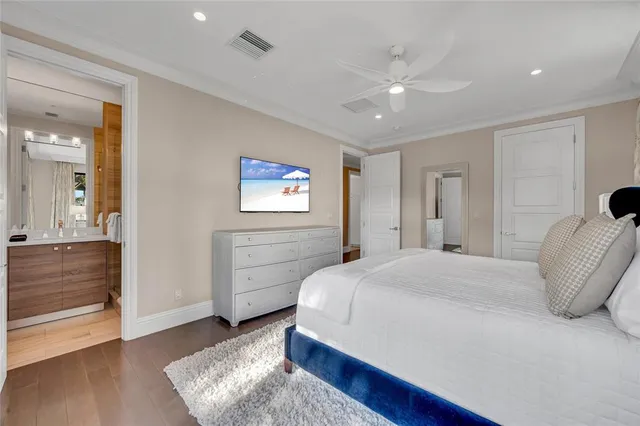 a spacious bedroom with a bed and a dresser