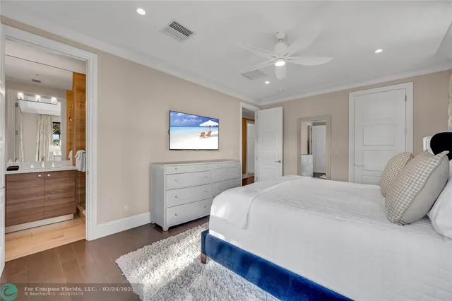 a spacious bedroom with a bed and a dresser