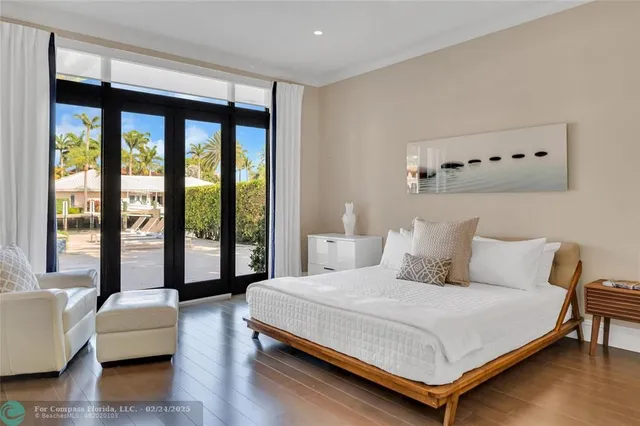a bedroom with a bed and a couch next to a window