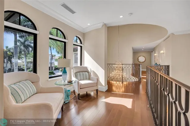 a living room with furniture and a floor to ceiling window