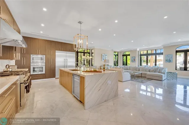 a large kitchen with stainless steel appliances granite countertop a large counter top and a stove