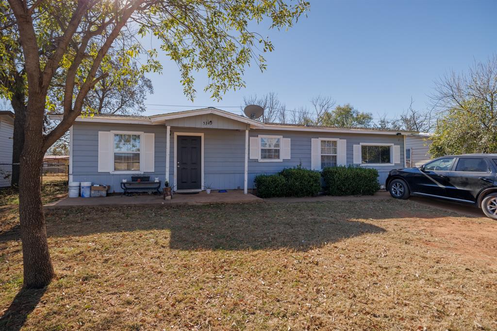 5349 Encino Road Abilene, TX 79605 - Photo 1 of 21 a front view of a house with a yard and garage