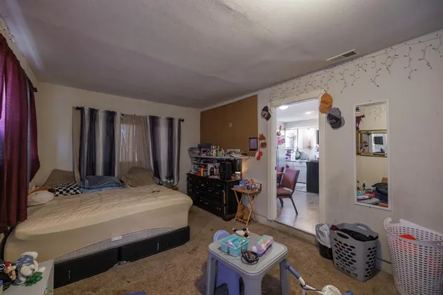 a bedroom with furniture and a wooden floor