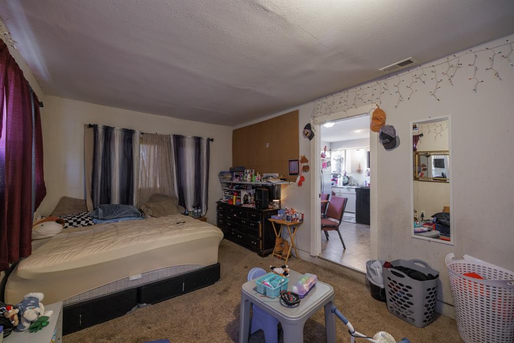 5349 Encino Road Abilene, TX 79605 - Photo 14 of 21 a bedroom with furniture and a wooden floor