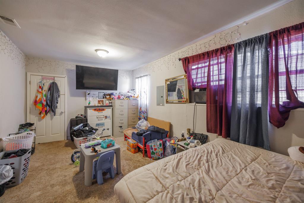 5349 Encino Road Abilene, TX 79605 - Photo 15 of 21 a bedroom with a bed a flat screen tv and dresser