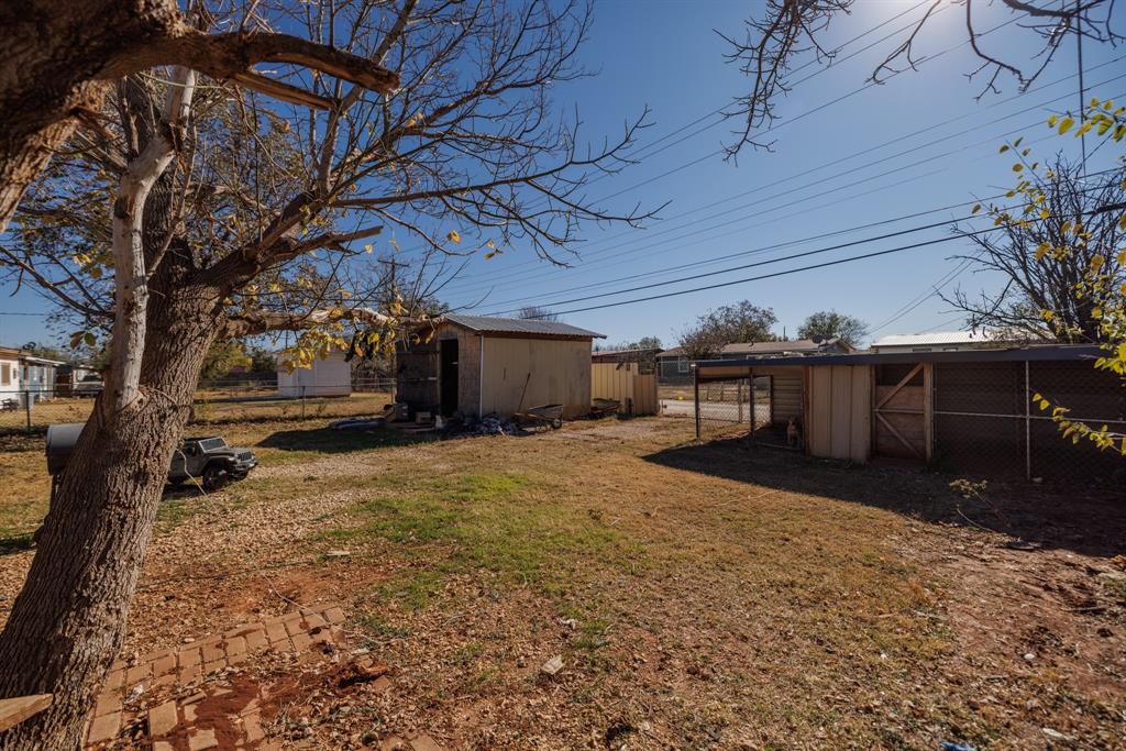 5349 Encino Road Abilene, TX 79605 - Photo 21 of 21 a view of a yard with table and chairs under an umbrella