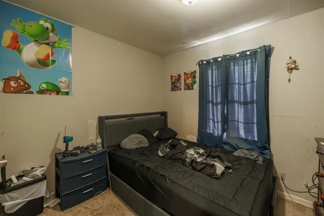 a bed sitting in a bedroom next to a window