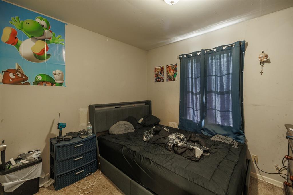 5349 Encino Road Abilene, TX 79605 - Photo 6 of 21 a bed sitting in a bedroom next to a window