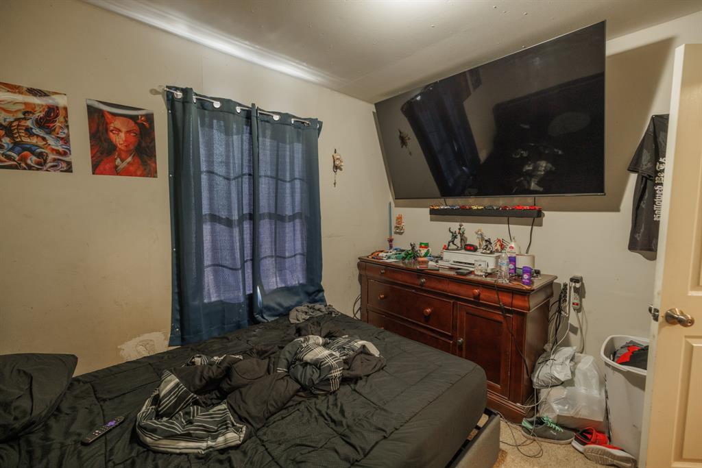 5349 Encino Road Abilene, TX 79605 - Photo 7 of 21 a bedroom with a bed and a television