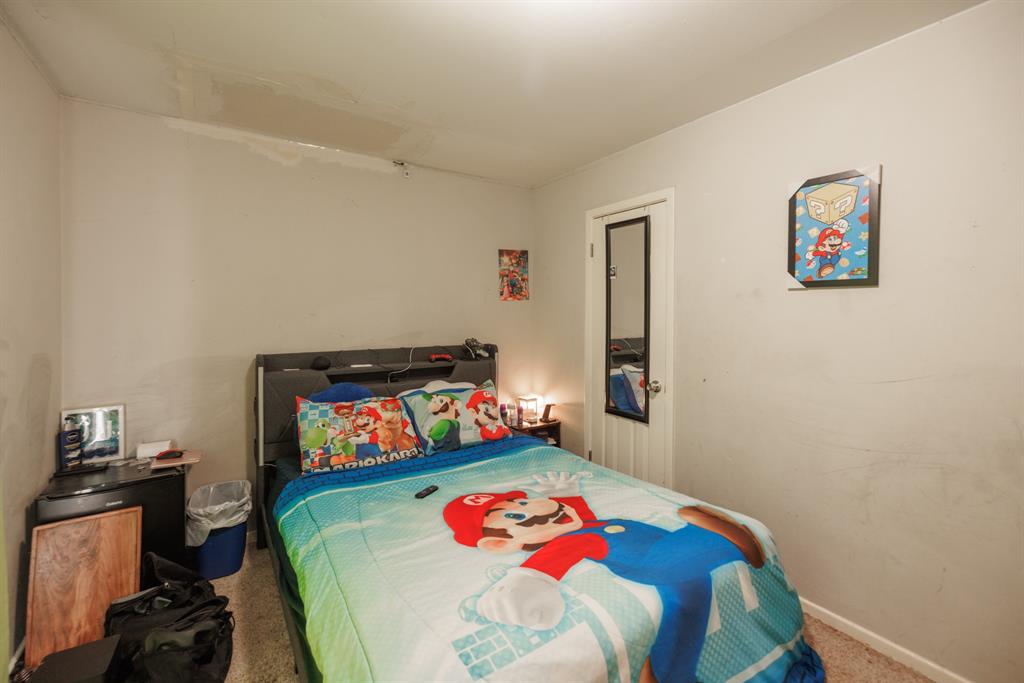 5349 Encino Road Abilene, TX 79605 - Photo 9 of 21 a bedroom with a bed and wooden floor