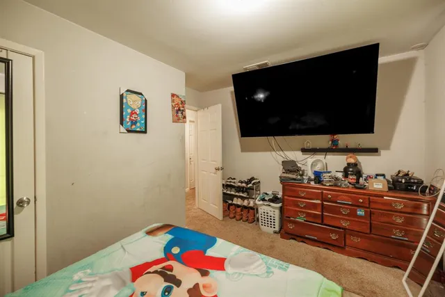 a bedroom with a bed and flat screen tv