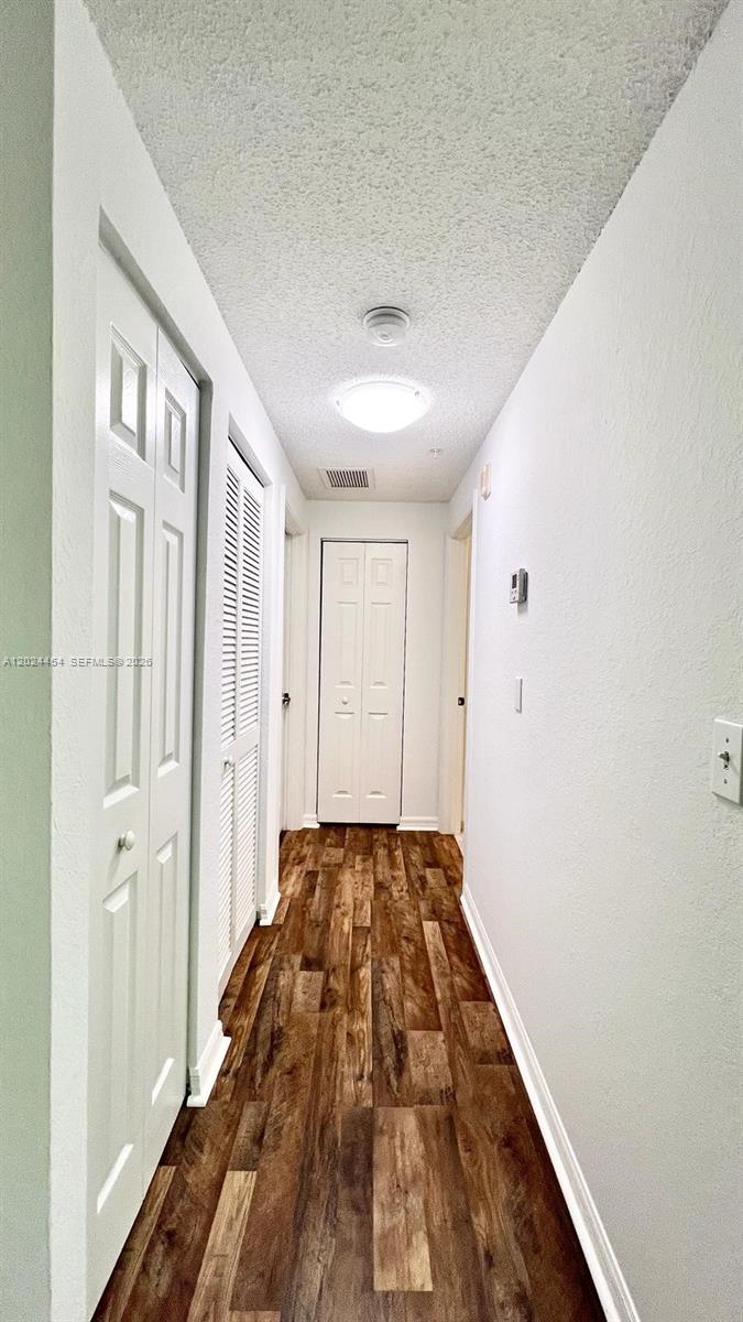 2727 Anzio Court, Unit 106 Palm Beach Gardens, FL 33410 - Photo 12 of 43 a view of a bedroom with wooden floor