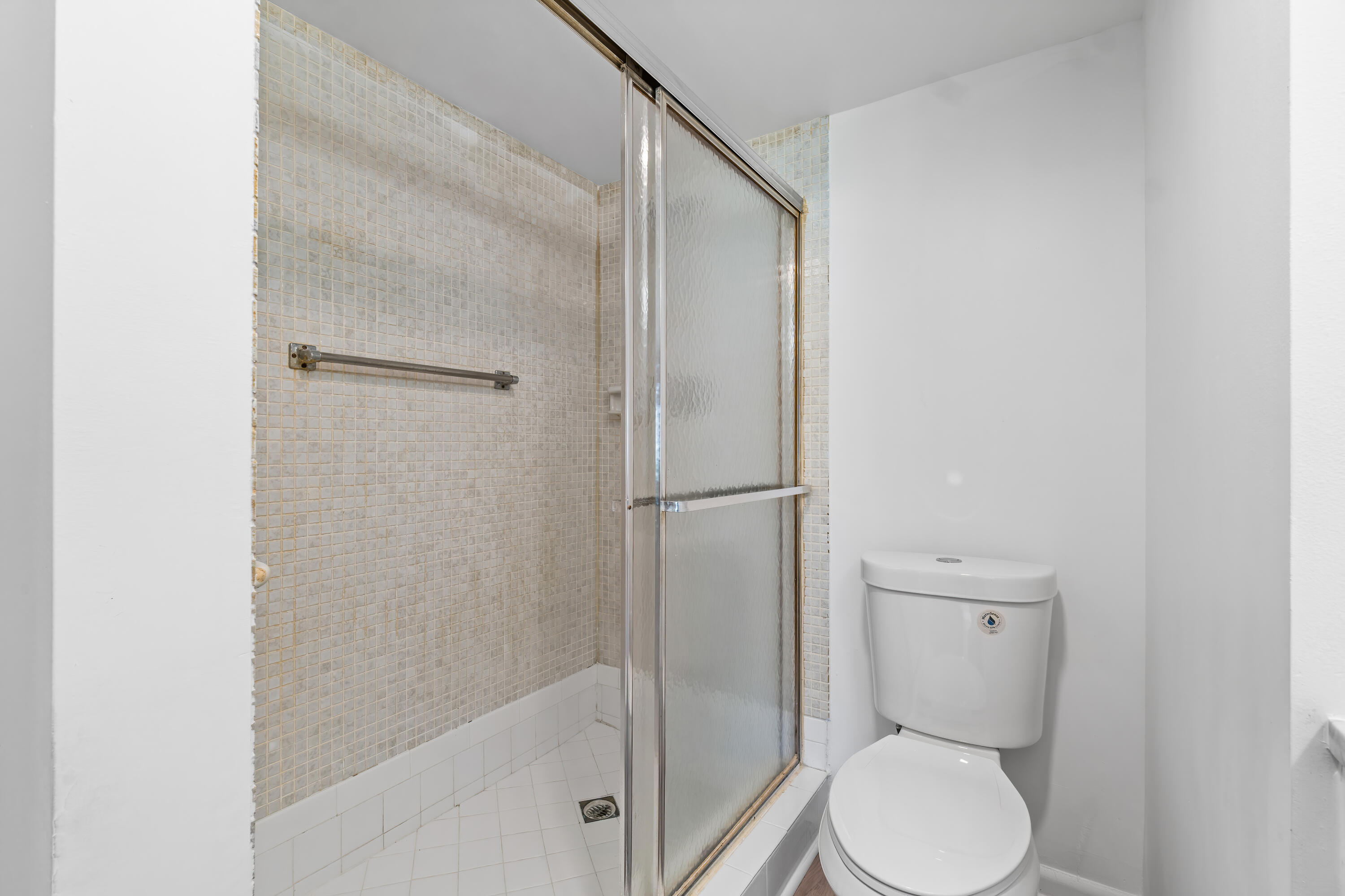 1007 Rexford Drive, Unit 1007 Boca Raton, FL 33434 - Photo 12 of 21 a bathroom with a toilet and a shower