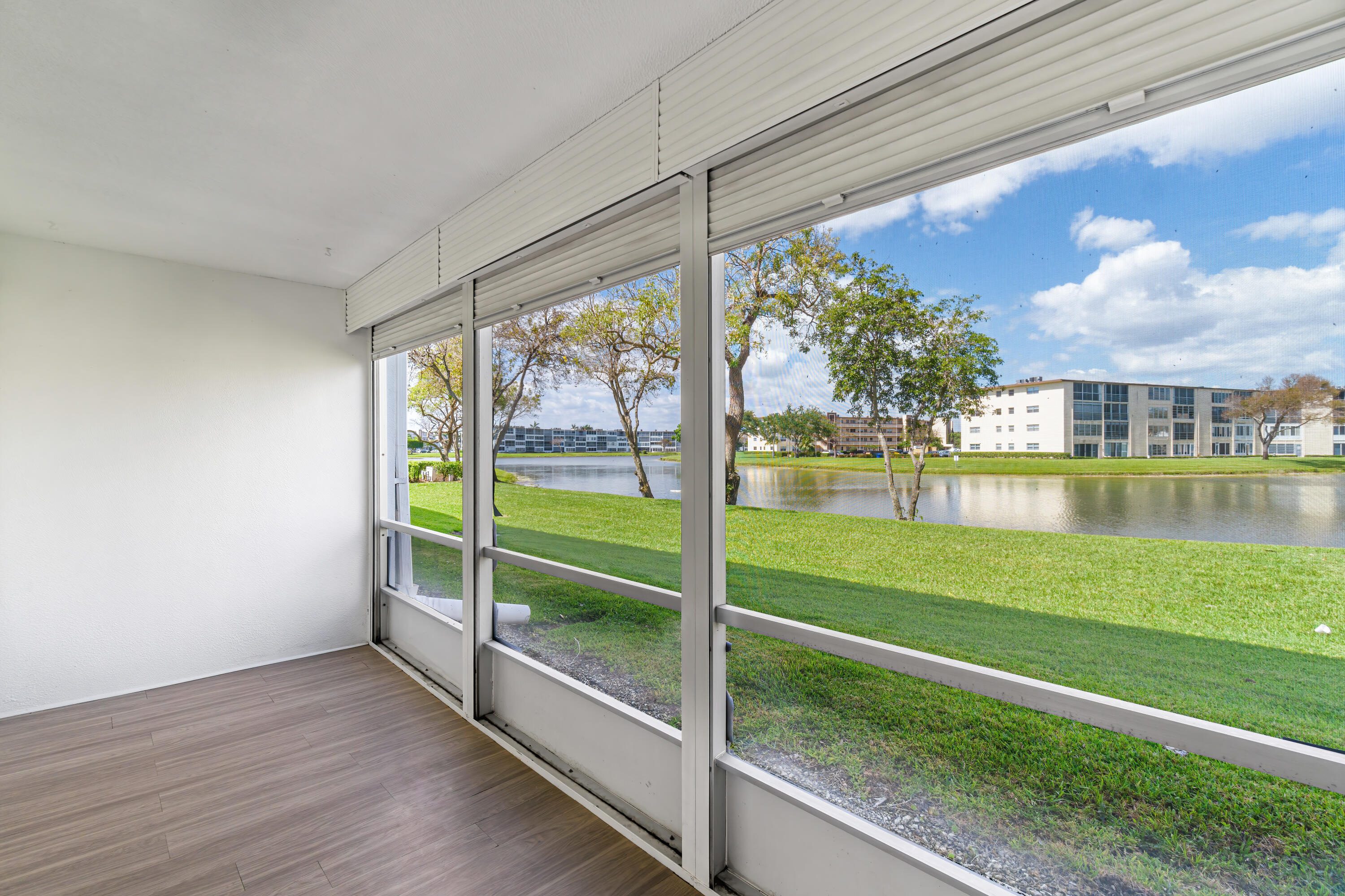 1007 Rexford Drive, Unit 1007 Boca Raton, FL 33434 - Photo 15 of 21 a view of a living room and floor to ceiling window