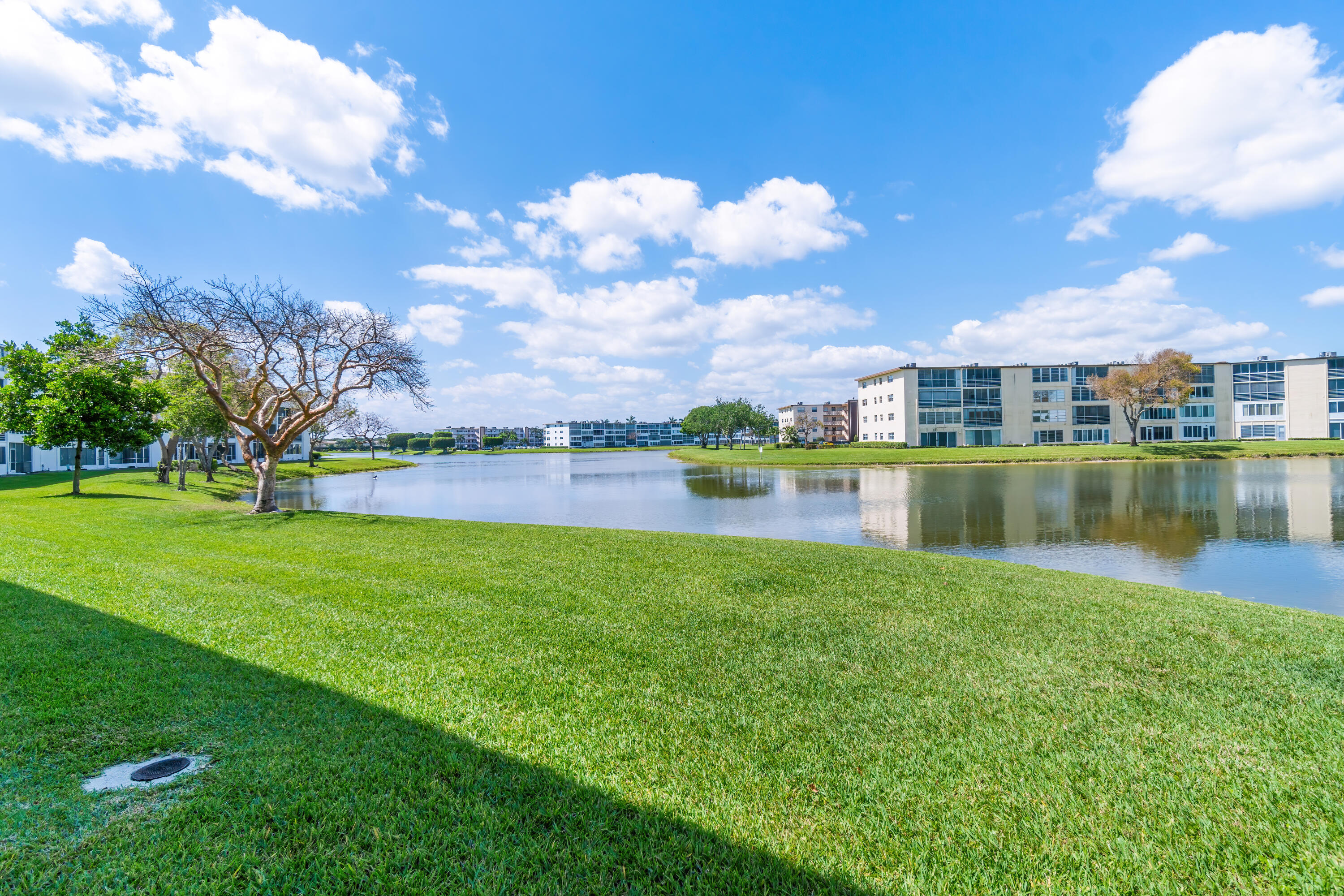 1007 Rexford Drive, Unit 1007 Boca Raton, FL 33434 - Photo 17 of 21 a view of a house with a yard and a garden