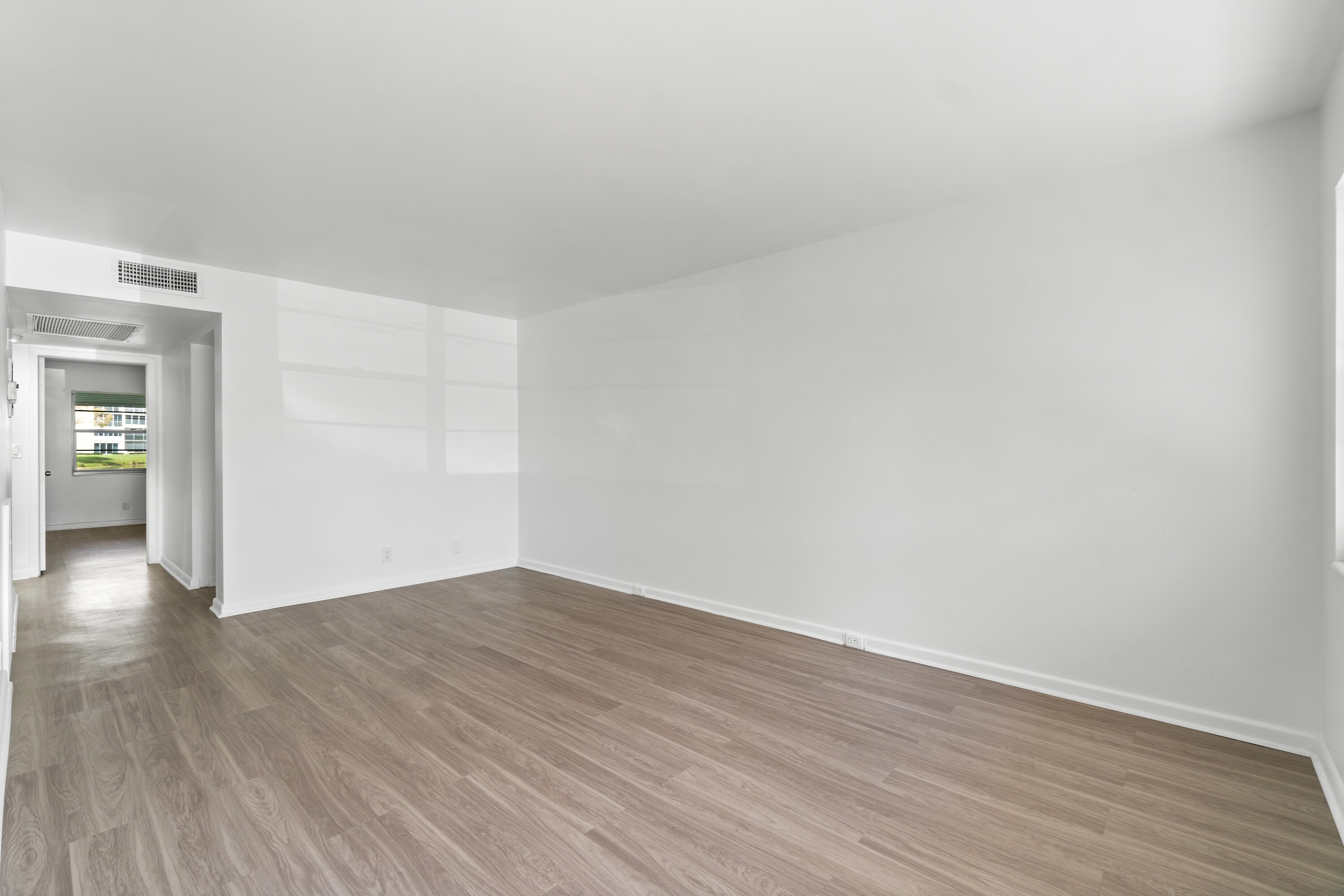 1007 Rexford Drive, Unit 1007 Boca Raton, FL 33434 - Photo 4 of 21 a view of an empty room and wooden floor