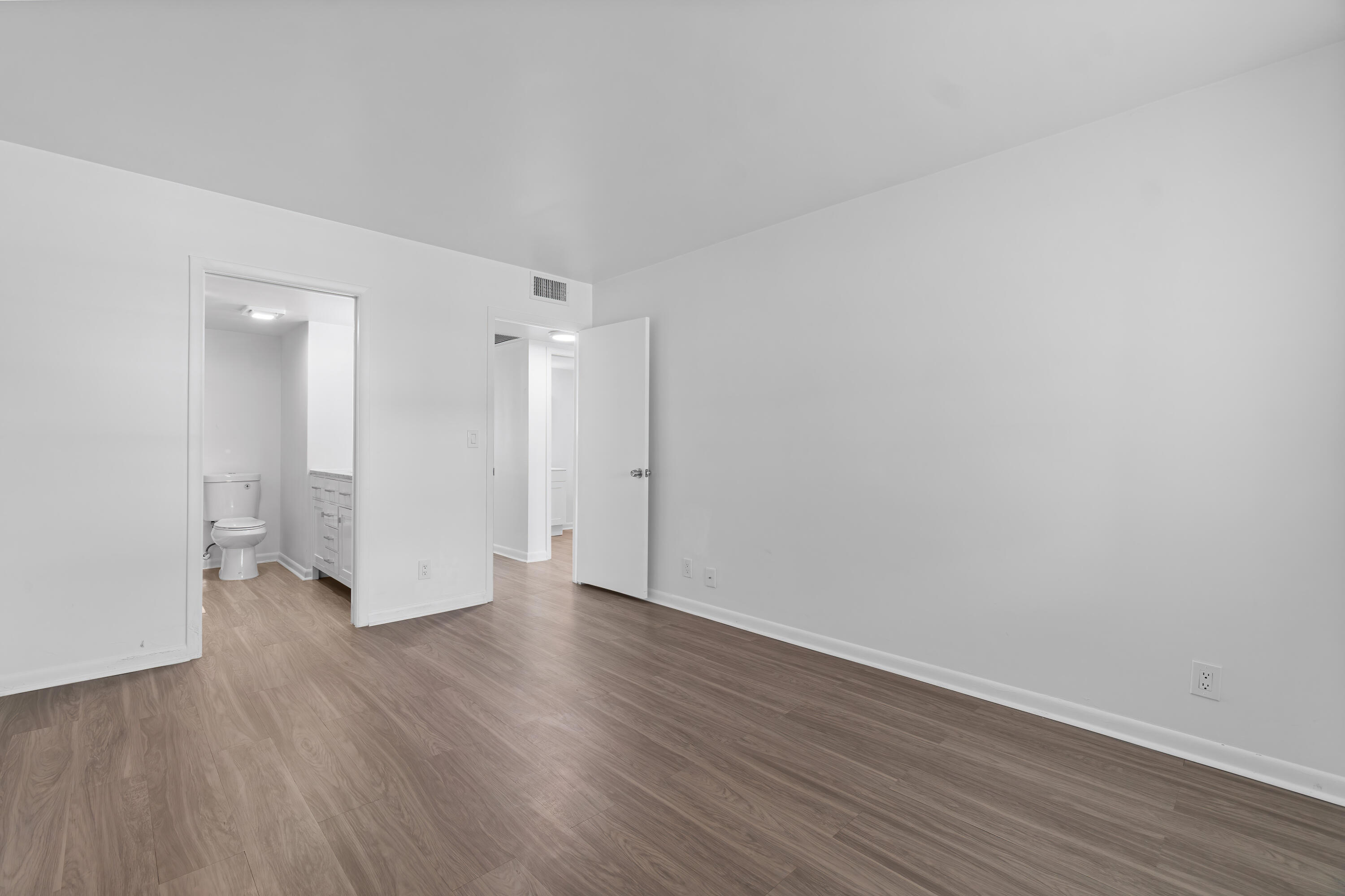1007 Rexford Drive, Unit 1007 Boca Raton, FL 33434 - Photo 7 of 21 a view of a room with wooden floor and white doors