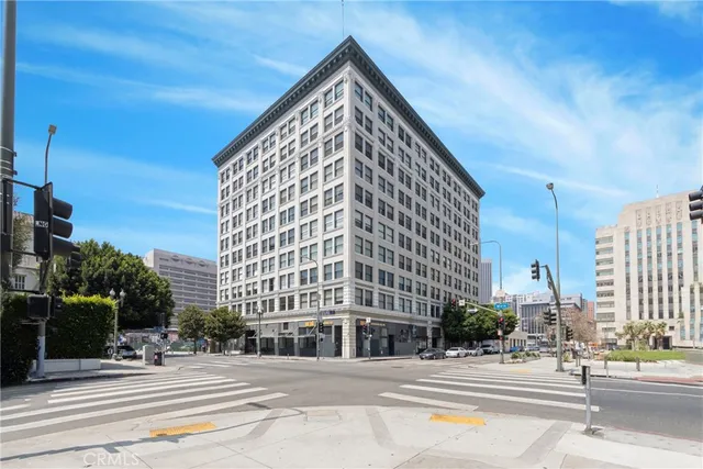 a view of a building with yard and sitting area