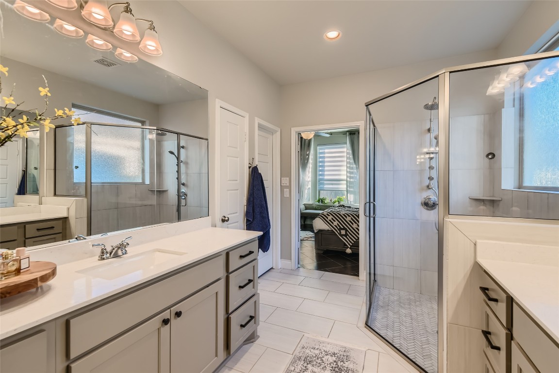 242 Freeman Loop Liberty Hill, TX 78642 - Photo 14 of 25 Full bathroom featuring vanity, plenty of natural light, light tile patterned floors, and recessed lighting