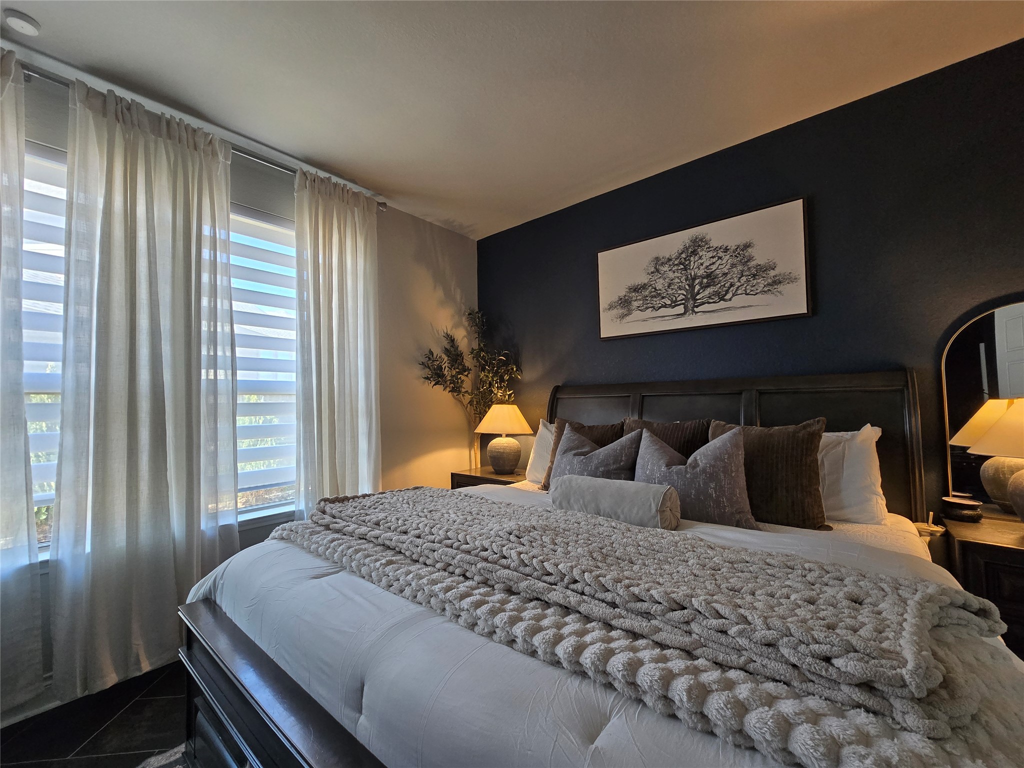 242 Freeman Loop Liberty Hill, TX 78642 - Photo 16 of 27 a bedroom with bed and wooden floor