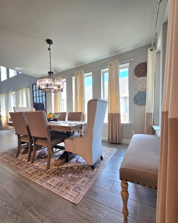 242 Freeman Loop Liberty Hill, TX 78642 - Photo 6 of 25 Dining room featuring wood finished floors and a chandelier