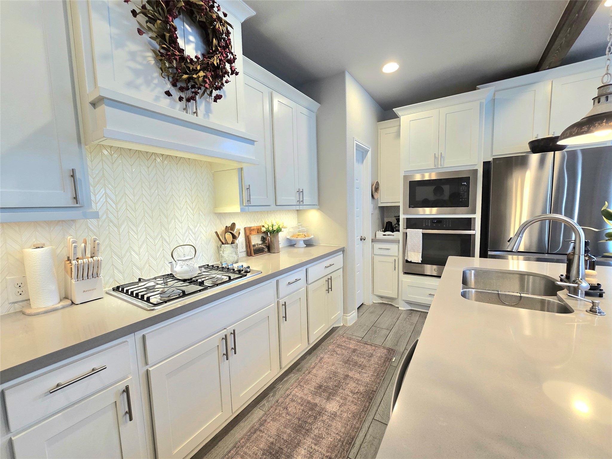 242 Freeman Loop Liberty Hill, TX 78642 - Photo 8 of 27 a kitchen with stainless steel appliances granite countertop a sink stove and refrigerator