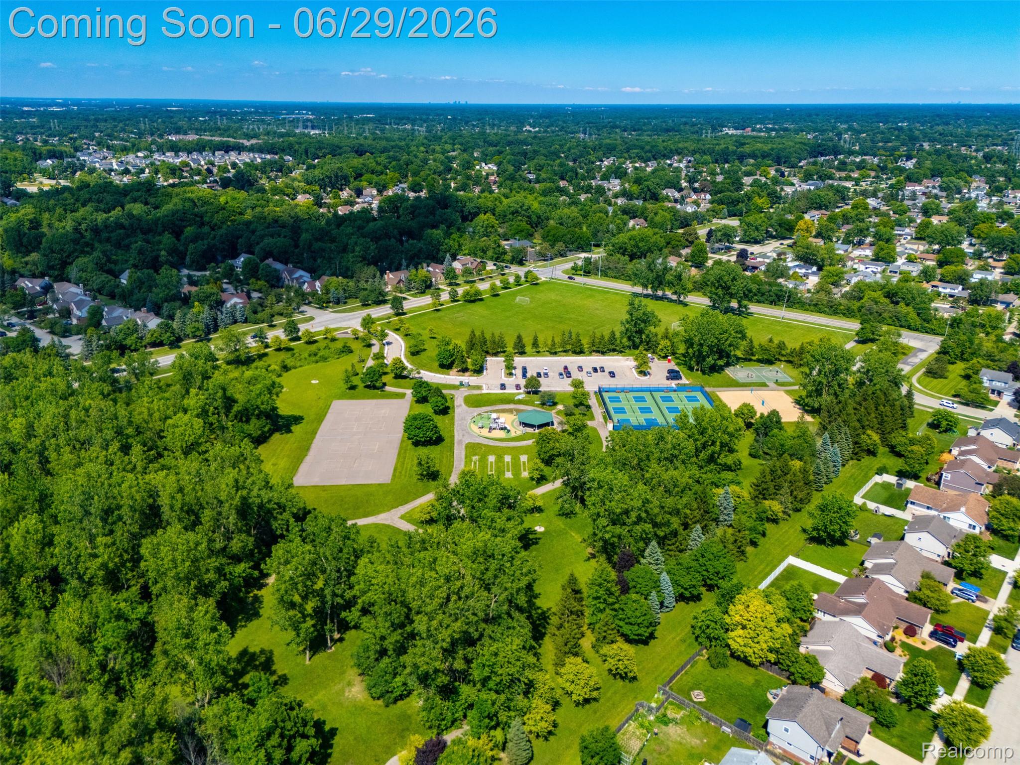 45179 Rudgate Road Canton, MI 48188 - Photo 41 of 48 Aerial perspective showcasing extensive green spaces, a manicured sports field, multiple tennis courts, a playground area, and mature tree coverage
